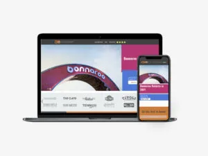 AC Entertainment website displayed in laptop and iPhone