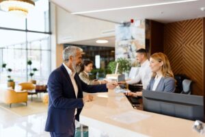 Man paying something with a credit card at the hotel reception